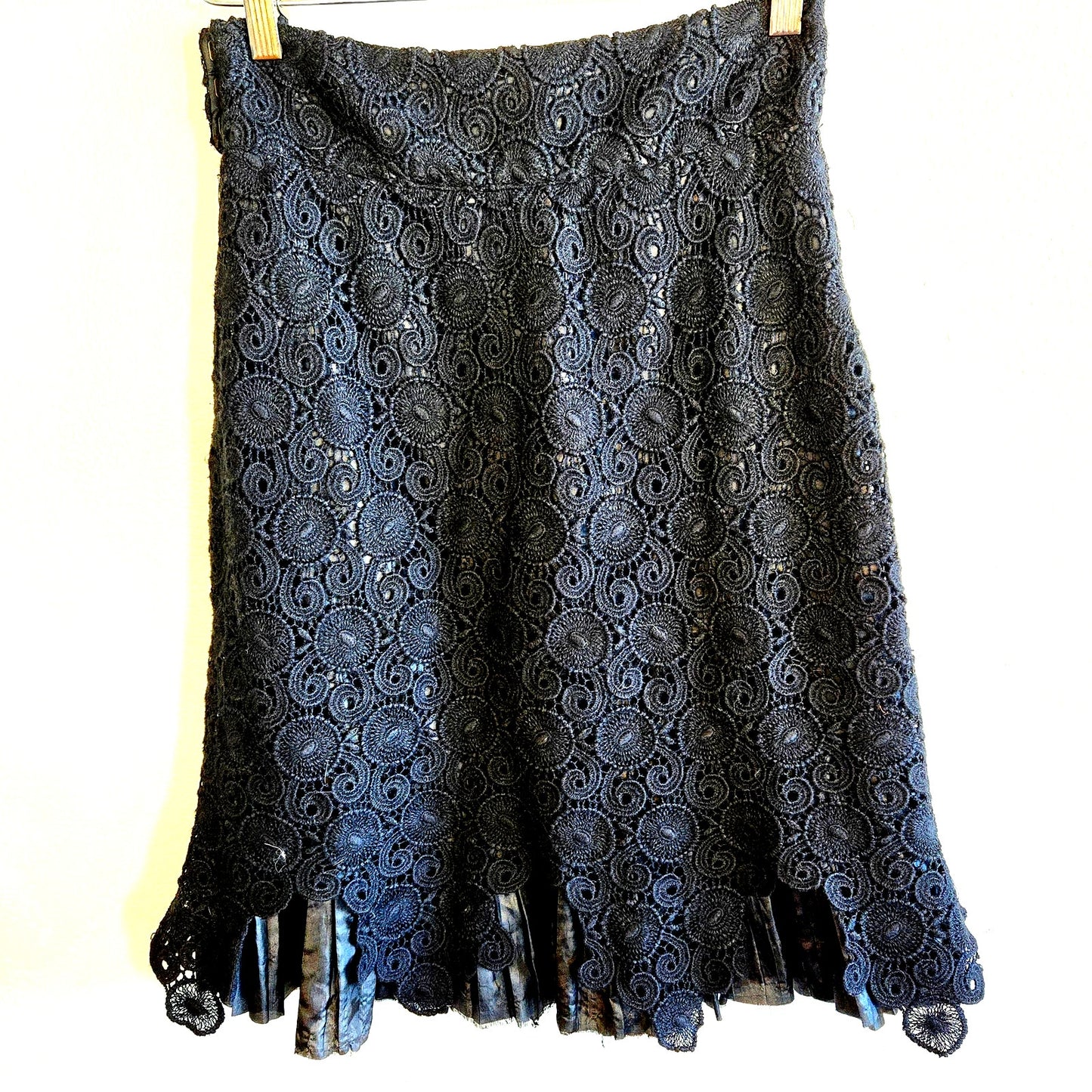Size 2 – Anthropologie black crochet overlay skirt with pleated satin hem